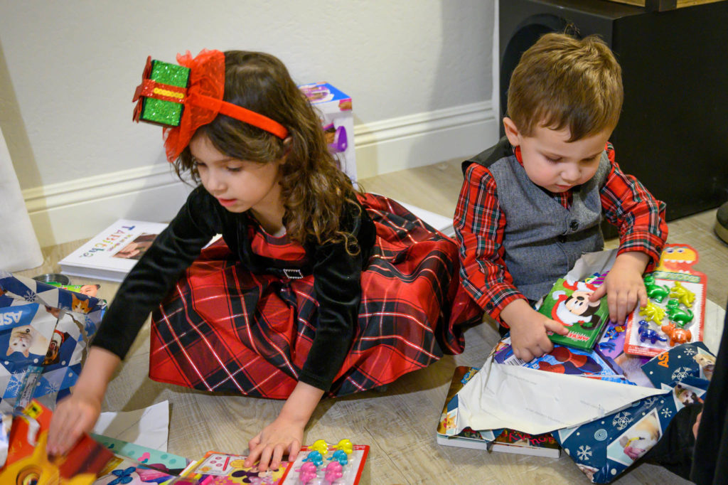 Tabitha and Ace unwrapping some of their gifts from their cousins. Christmas Eve, 2019